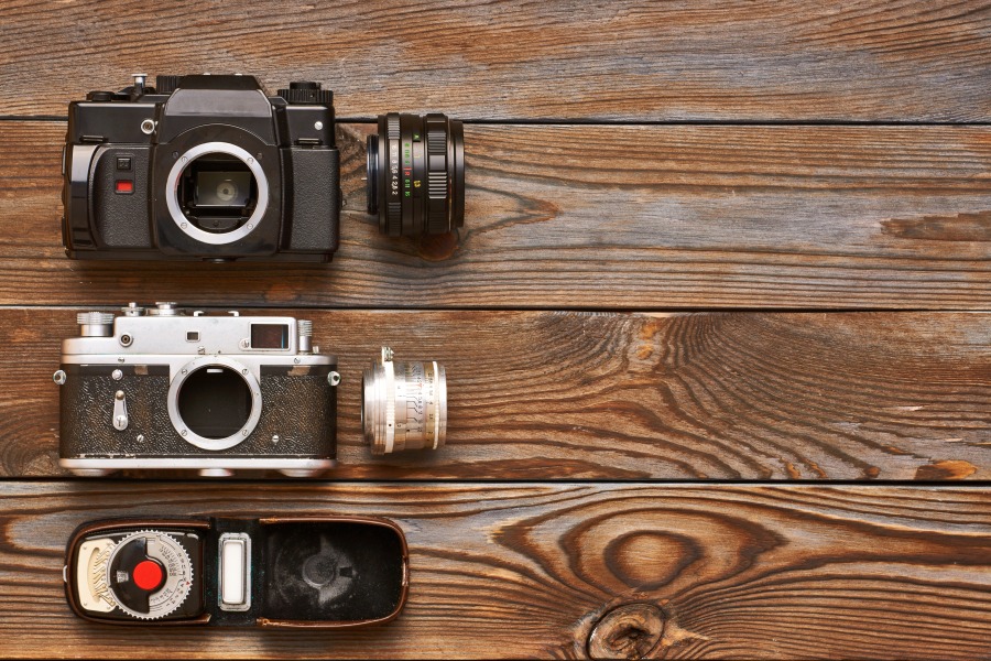 vintage cameras and lenses on wooden background 2021 08 26 16 19 15 utc