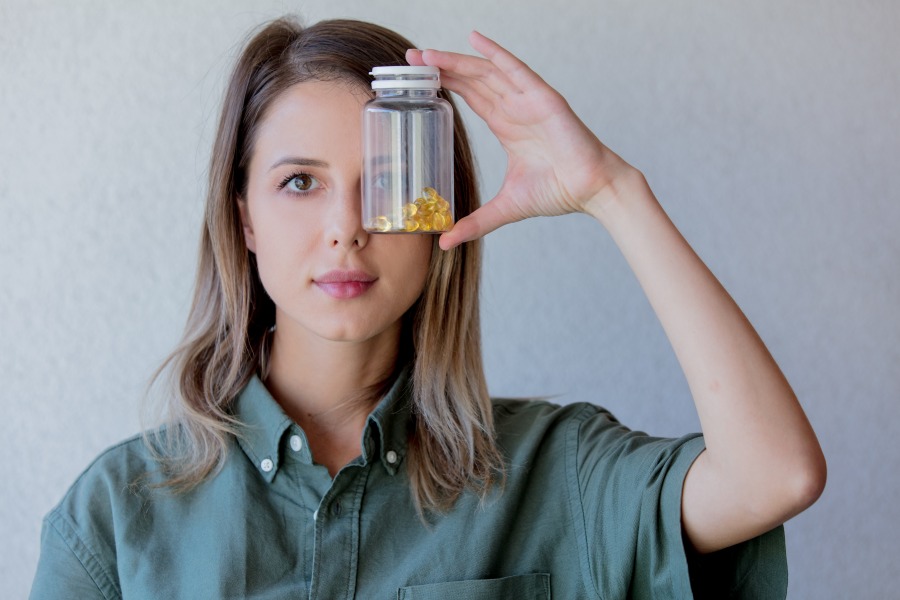 woman keeps transparent jar with pills at eye leve 2022 01 07 00 50 08 utc 1